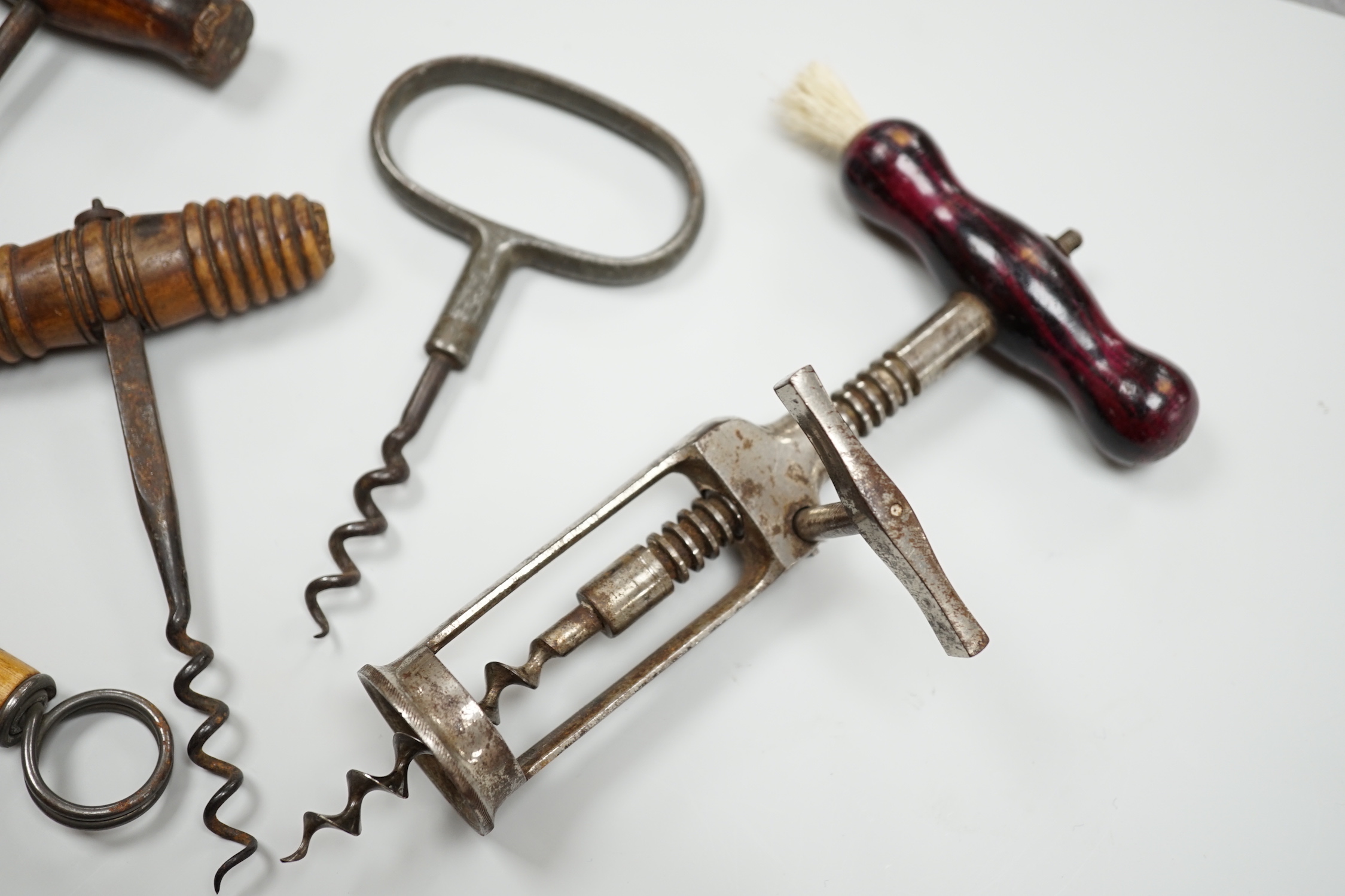 A 19th century iron corkscrew, with a turned wood handle and four other corkscrews (5)
